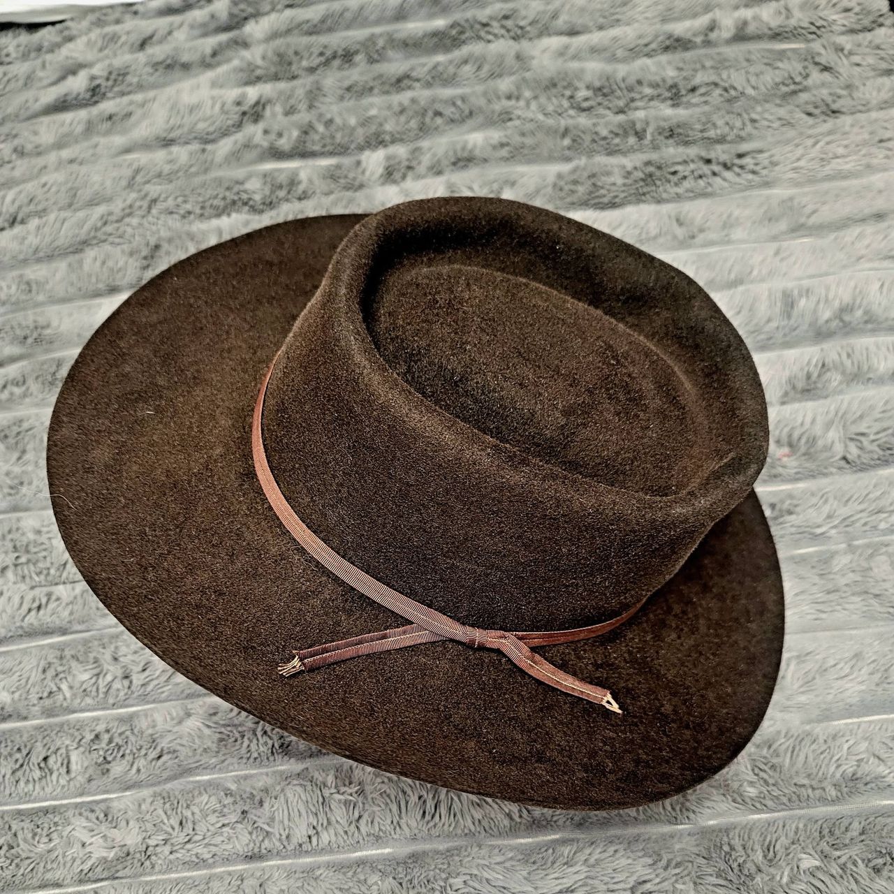 Restored vintage brown western hat on a stand